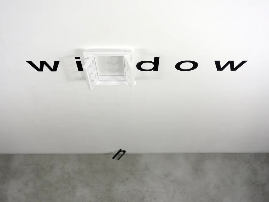 one word drama, seen from the side, the fallen letter on the floor