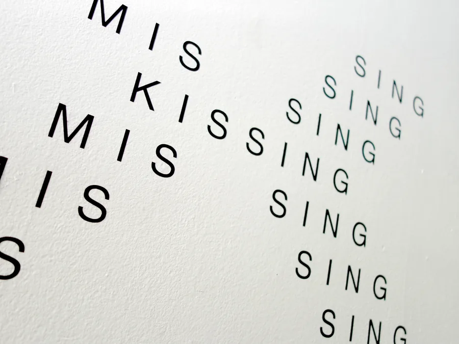love song, seen from the side, the letters running across the wall