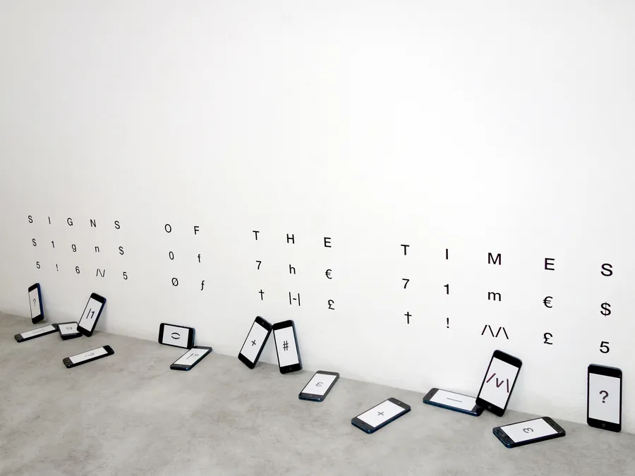 signs of the times, seen from the side, the phones lying along the wall
