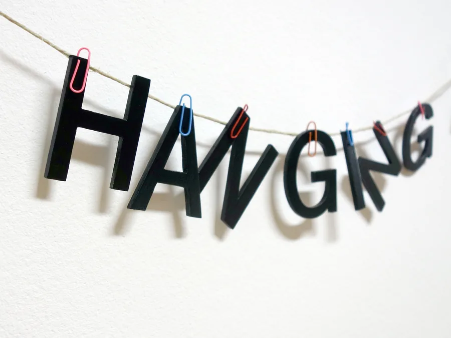 just hanging around, detail, the letters clipped to the line