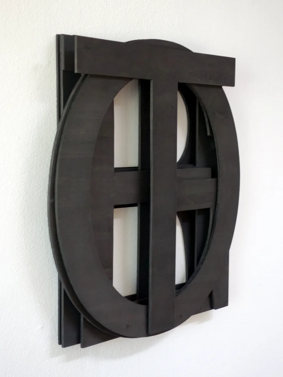 (sticking) TOGETHER, seen from the side, the wooden letters lying over each other