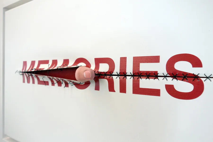 memories, seen from the side, the word cut open and sewn