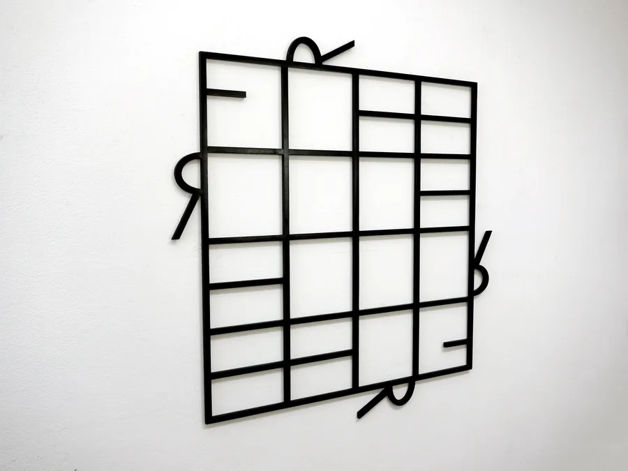 paradox of freedom, the barred grid on the wall with the letters hooked around it
