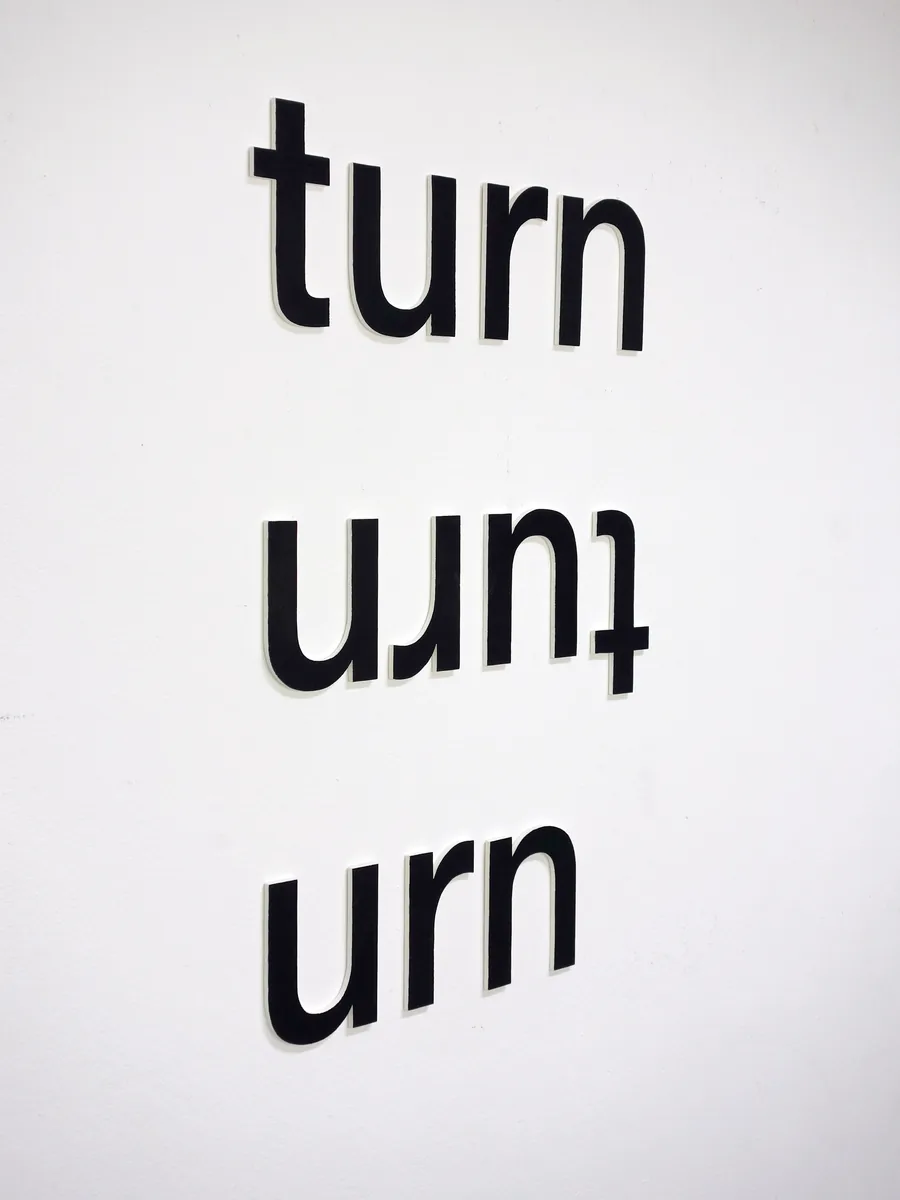 no matter how you turn it, the three words on the wall