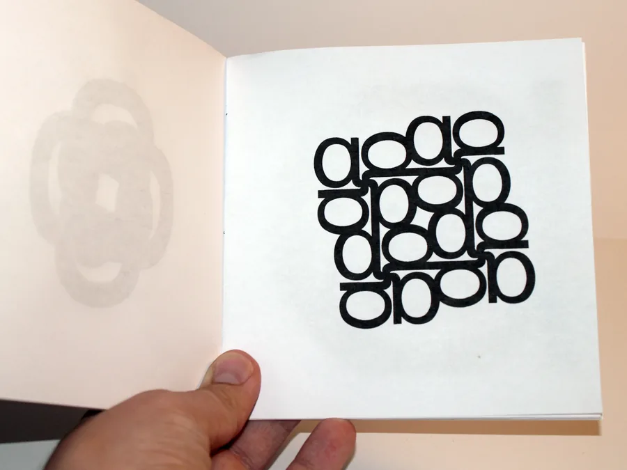 A chapbook, an open page held in one hand